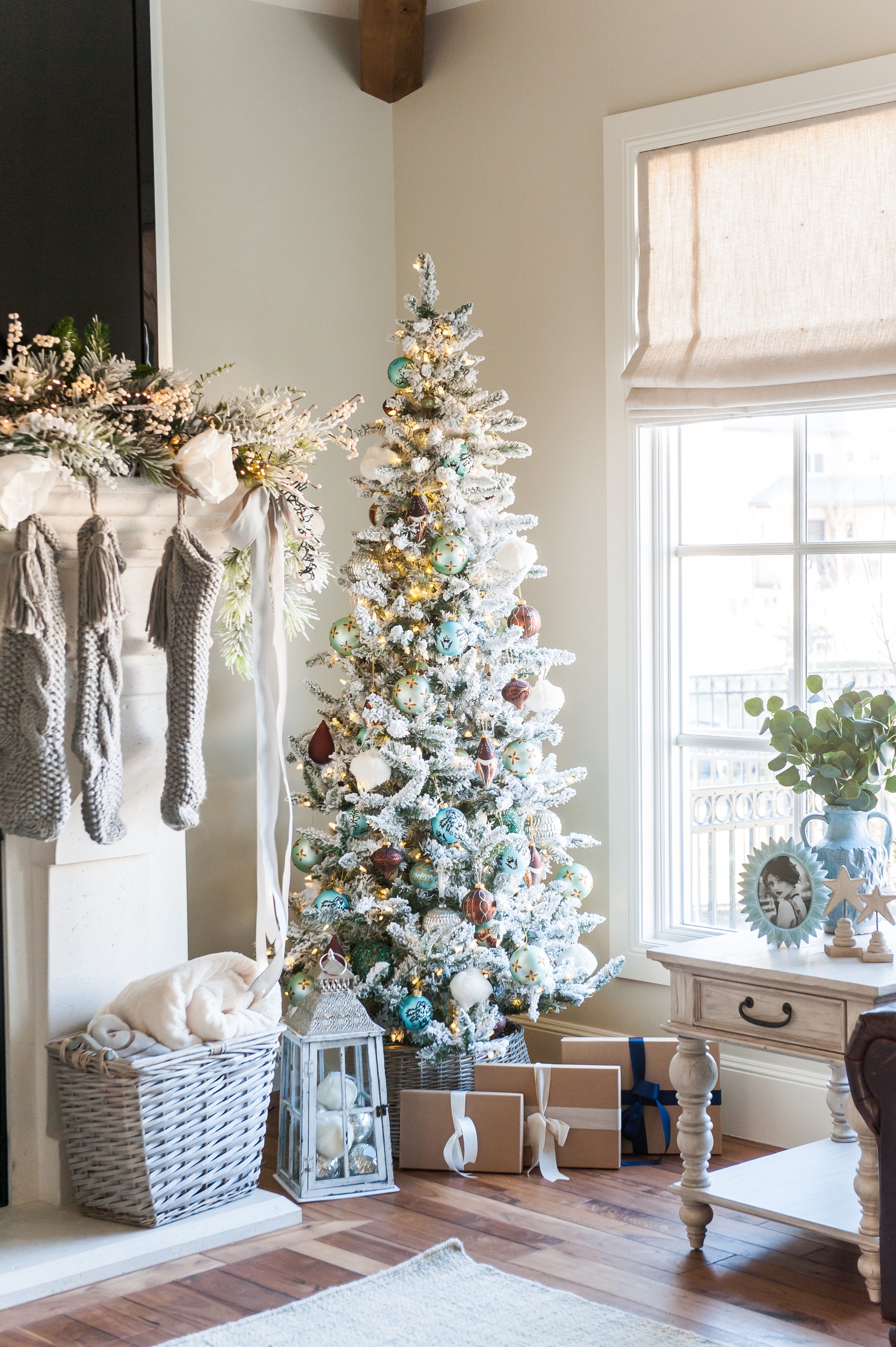 Christmas tree flocked long needle pine christmas tree flocked tree blue decor blue christmas ornaments trimming the tree shades of blue on white blue and cream flocked long needle pine artificial tree blue white ivory cream silver ornaments plaid ribbon