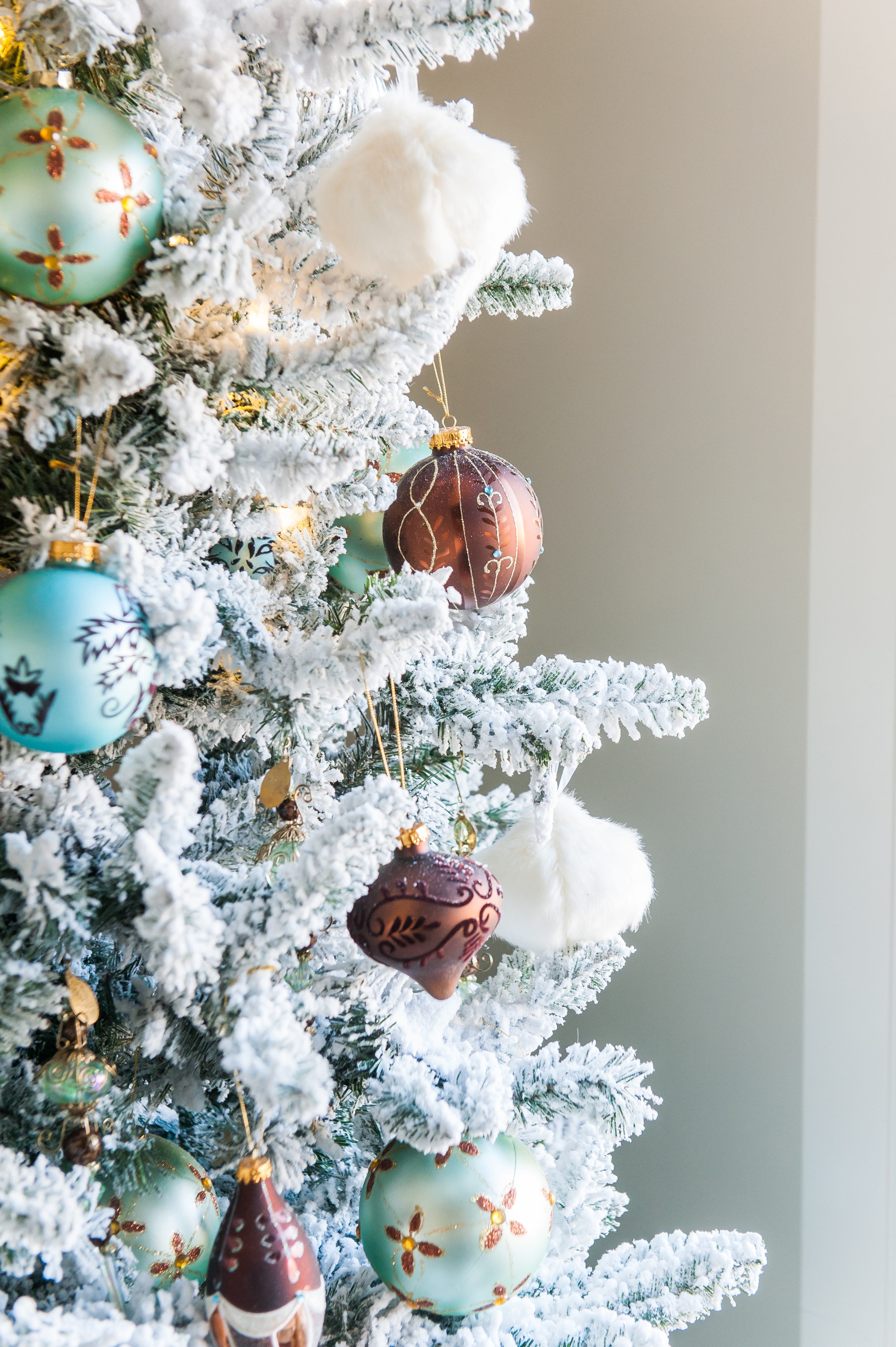 Christmas tree flocked long needle pine christmas tree flocked tree blue decor blue christmas ornaments trimming the tree shades of blue on white blue and cream flocked long needle pine artificial tree blue white ivory cream silver ornaments plaid ribbon