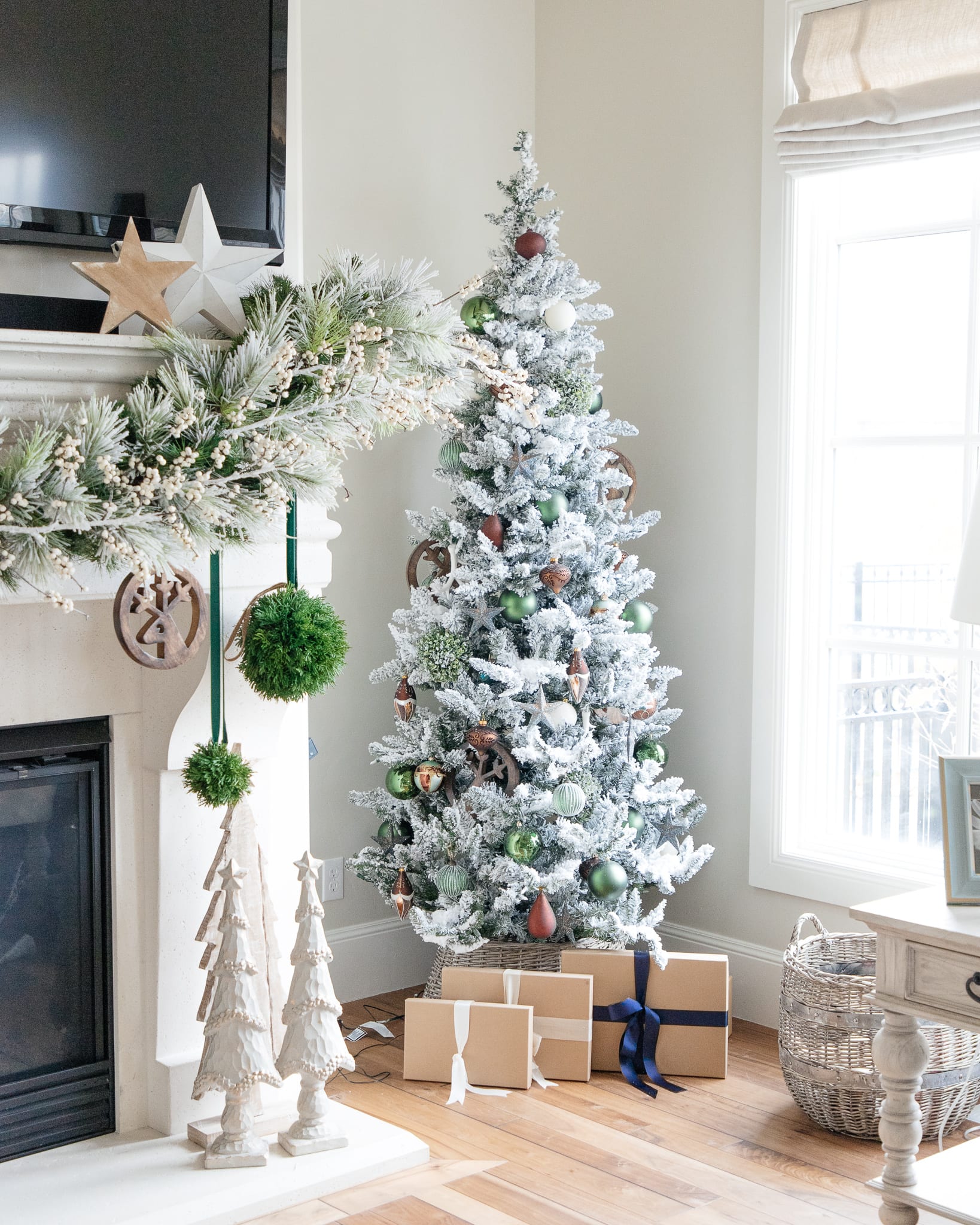 Christmas tree flocked long needle pine christmas tree flocked tree blue decor blue christmas ornaments trimming the tree shades of blue on white blue and cream flocked long needle pine artificial tree blue white ivory cream silver ornaments plaid ribbon