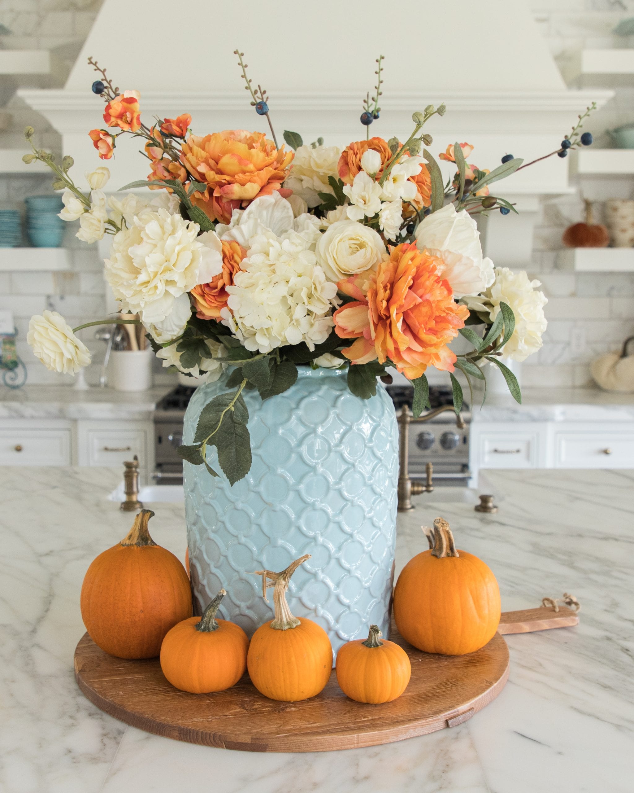 light blue and orange faux flower centerpiece