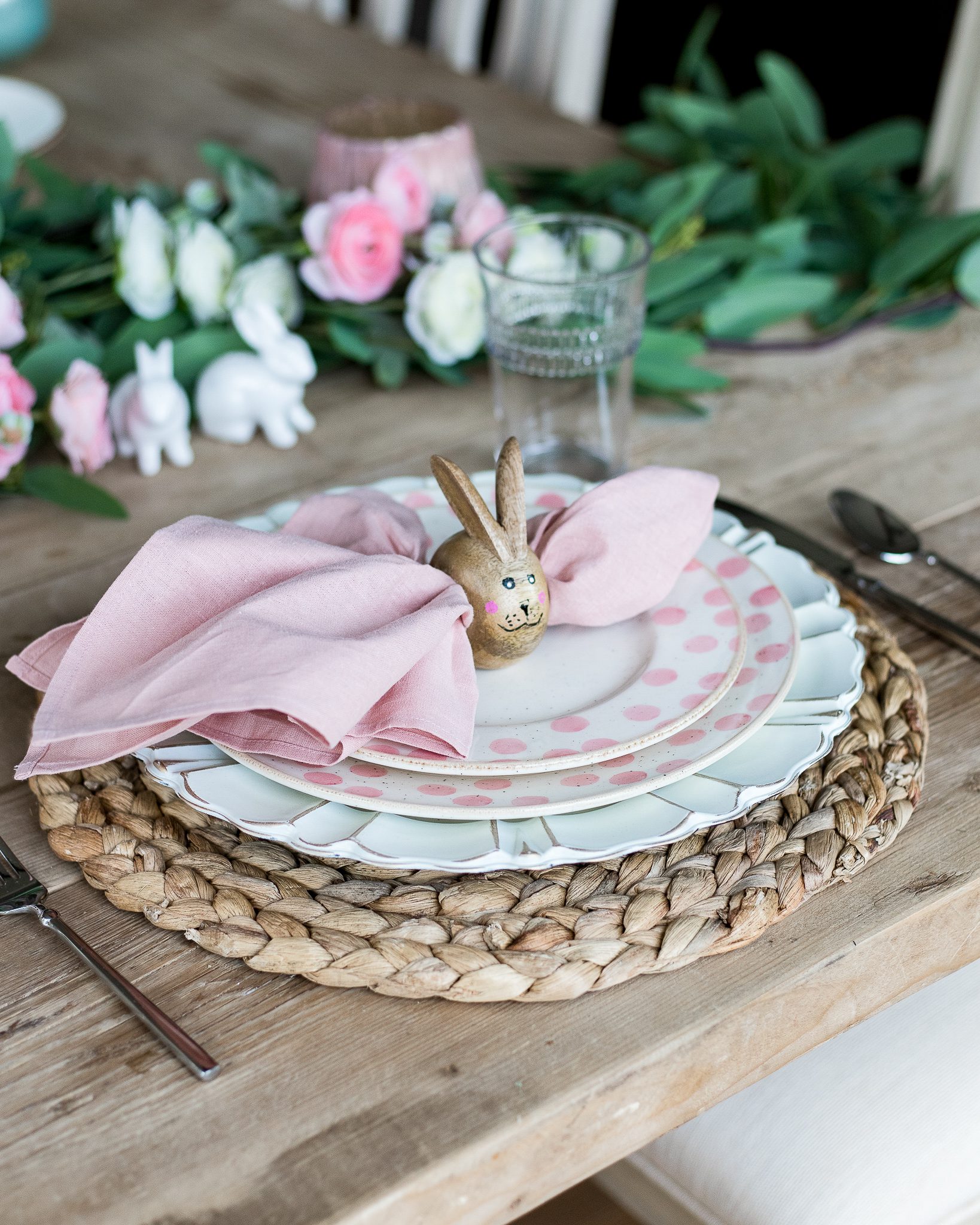 pink polka dot dinnerware and bunny ear napkin ring place setting