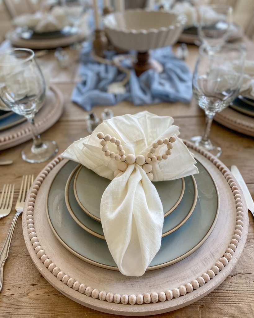 Create a beautiful tablescape for Easter with dusty blue and mango wood accents. Learn how to create this look right now!