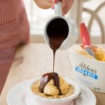pouring hot chocolate on homemade chocolate chip cazookie recipe