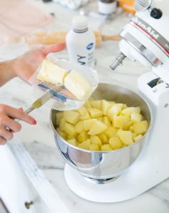 mashing potatoes in a stand mixer with butter