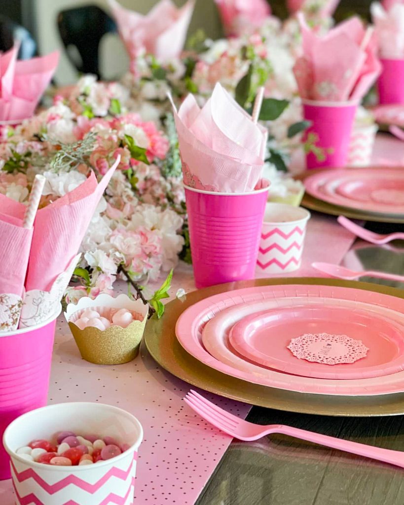 Pink paper plates on a table. You don't need fancy china to set a beautiful table. Elevate our dining experience with a pink paper plate tablescape.