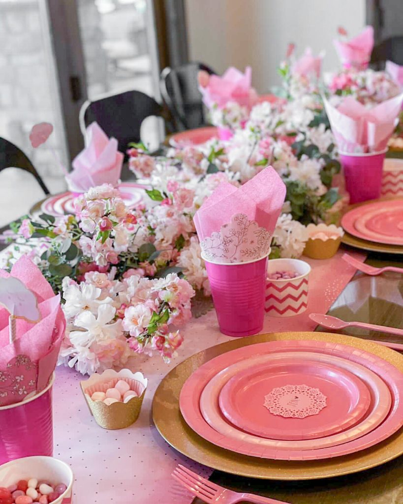 Pink paper plates on a table. You don't need fancy china to set a beautiful table. Elevate our dining experience with a pink paper plate tablescape.