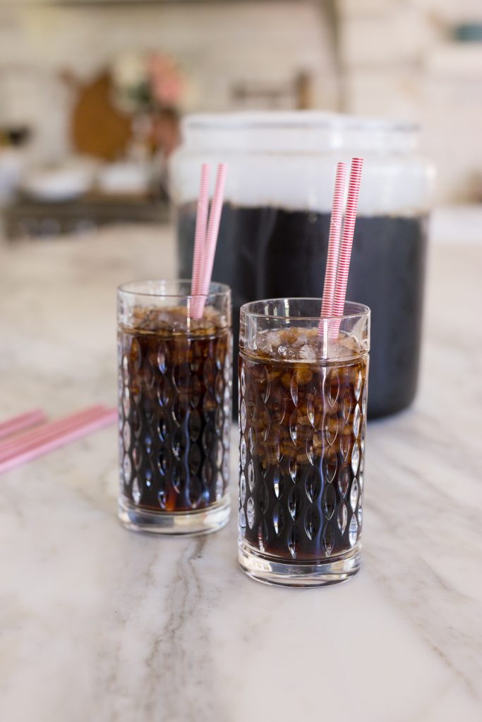 two glasses of homemade root beer with straws