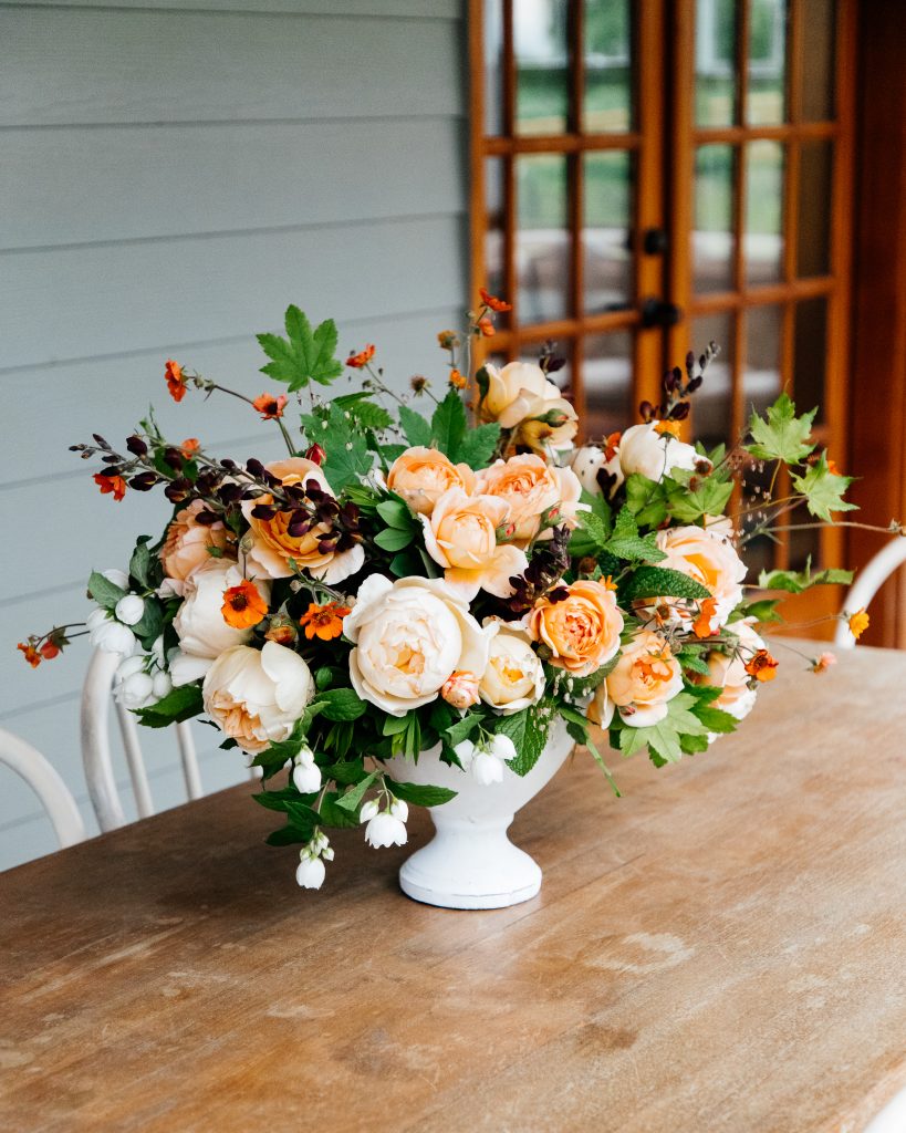 orange peony and rose flower arrangement 