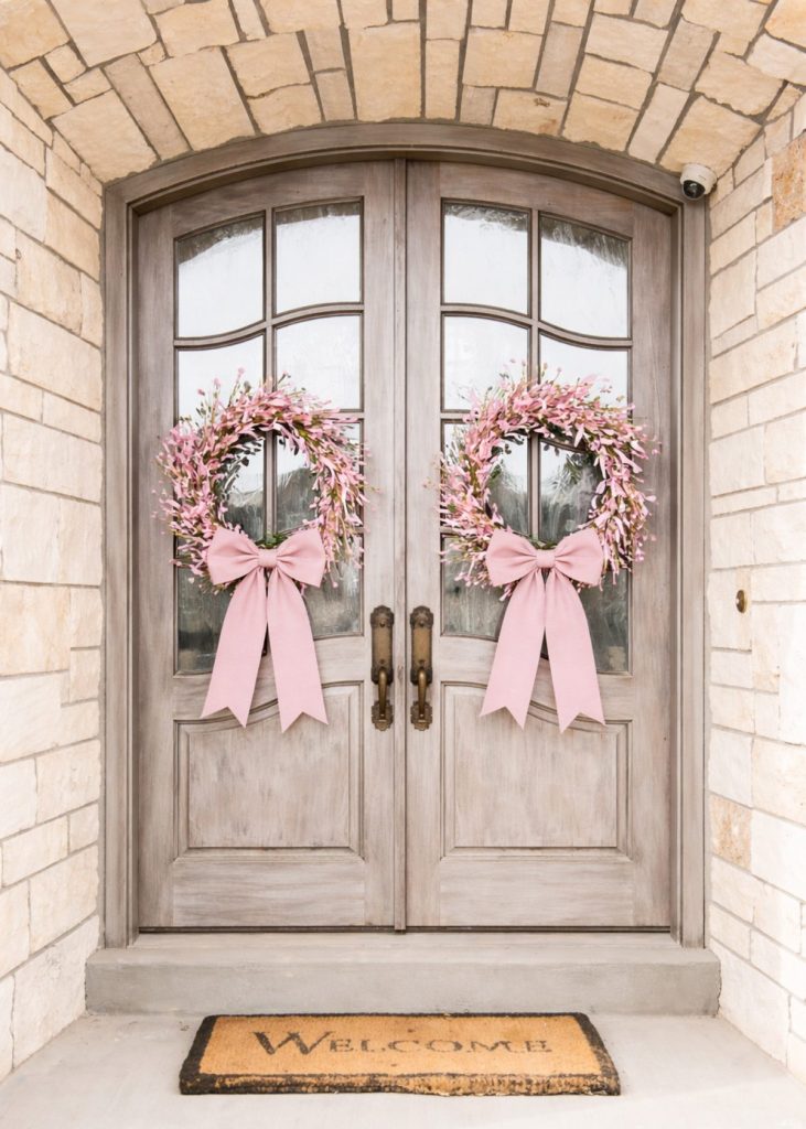 Rustic doors with cherry blossom wreaths
